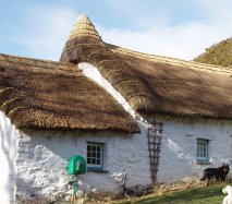 Traditional Welsh thatched roof with thatched chimney