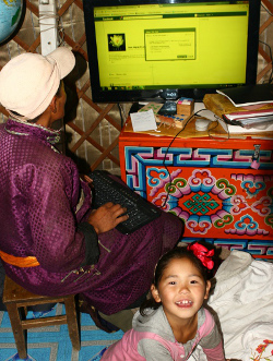  family looking at our Facebook page on a screen powered by a solar panel