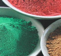 Samples of red, green and brown-coloured pigment for natural paint-making.