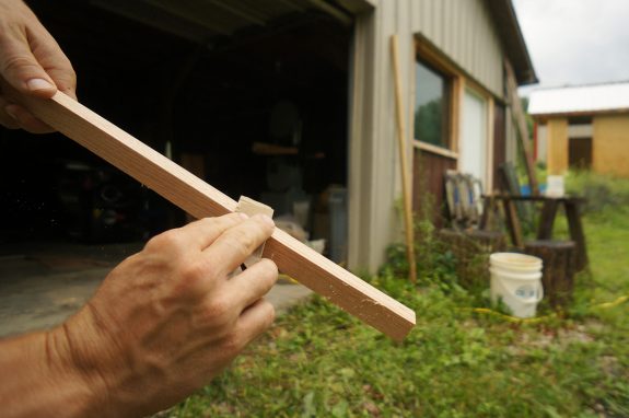 Sanding down the edges of the Japanese plaster hawk handle