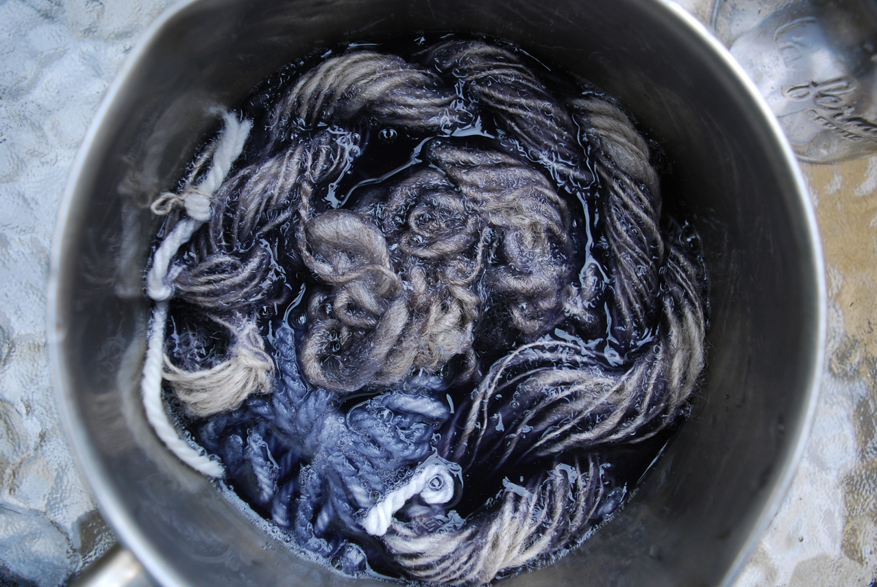 Blue dyed yarn in a dyepan