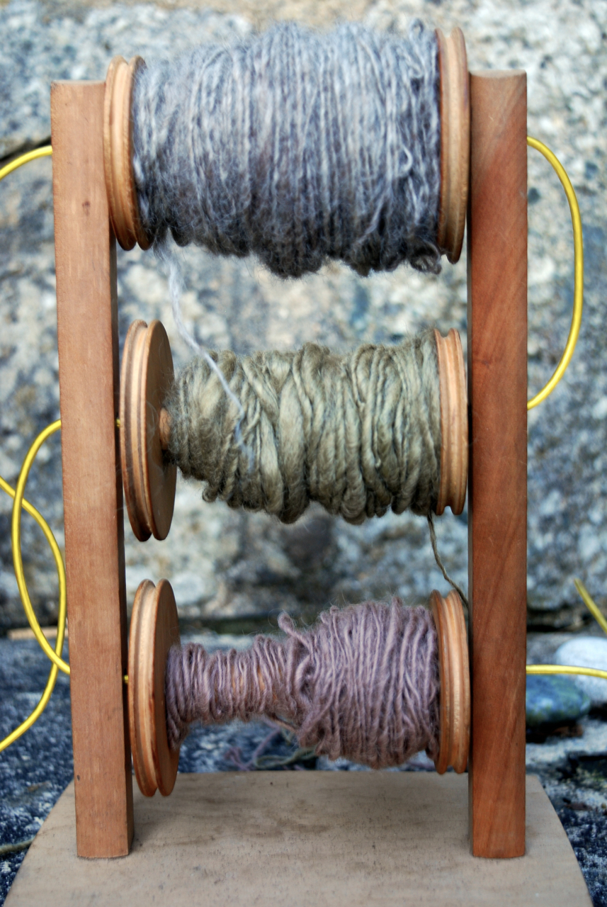 Freshly dyed and spun yarn on bobbins