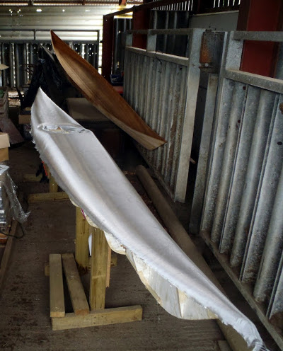 Building your own sea kayak: the woven fibreglass material is carefully placed