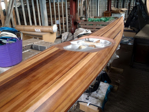 Building your own sea kayak: fibreglass wetted out and more epoxy added