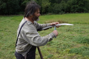 Sharpening the scythe ready for haymaking