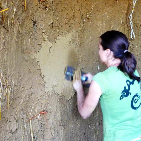 Applying the second coat of clay plaster