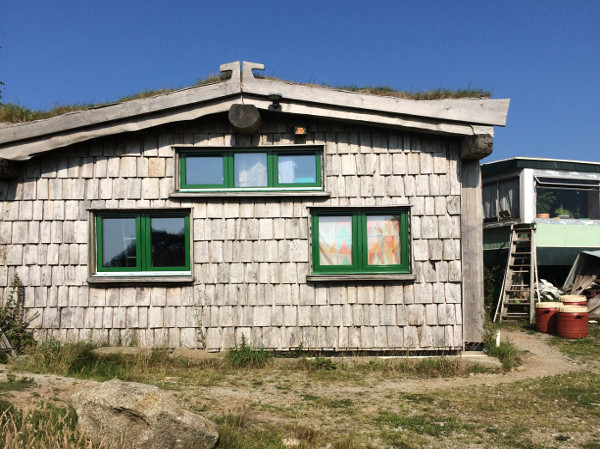 Three-bedroom, earth-sheltered house with a living roof, cob internal walls & sea view; cost: £18,000