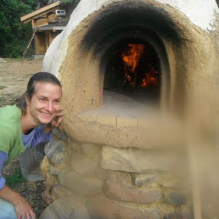 A blazing fire inside a finished cob oven