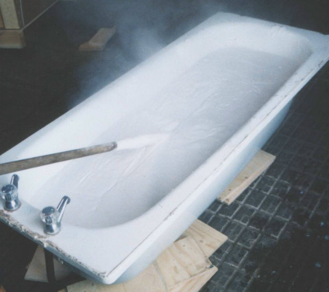 Slaking quicklime in an old bathtub