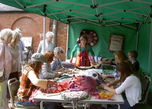 Rag-rug making session at Ludlow green fair. 