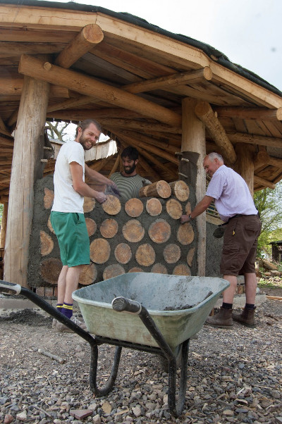 On site at a natural building camp involving cordwood construction